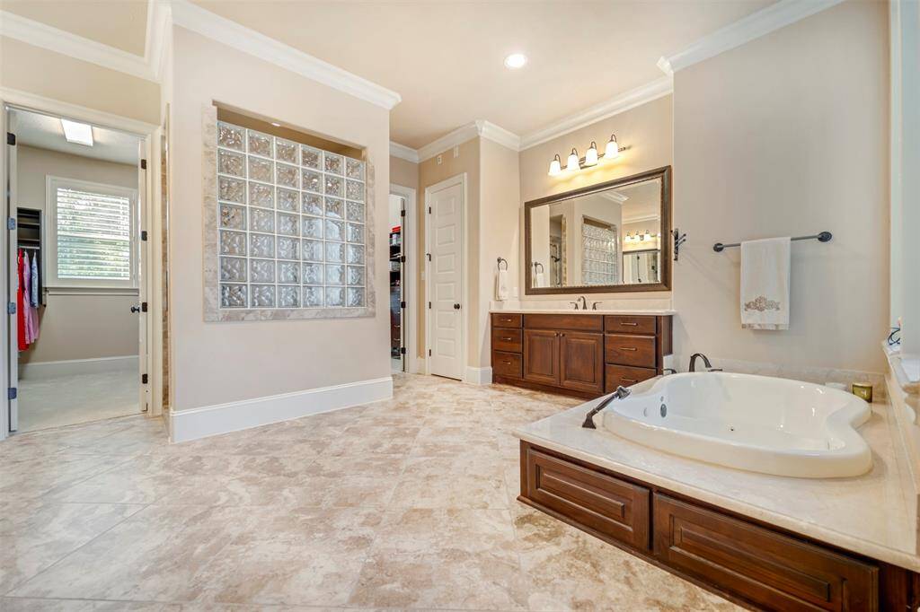 The primary bathroom is full of pairs!  A pair of vanities, a pair of closets, and separate shower, tub and water closet.  Everyone has their space and privacy in the primary bathroom!  So well designed!