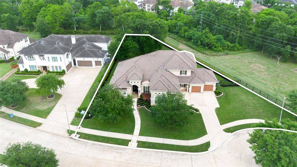 Property is located in a quiet cul-de-sac with a large, well-manicured front lawn and a four-car garage. It's surrounded by lush greenery, offering privacy and a serene environment. Ideal for families seeking a peaceful neighborhood.