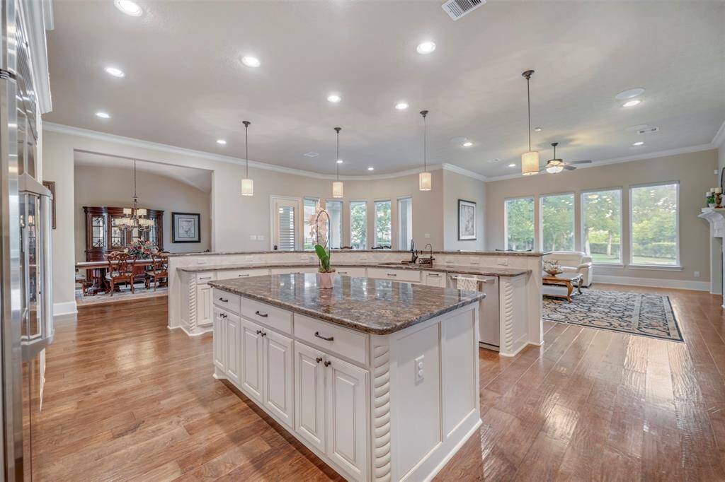 Notice the huge DOUBLE ISLANDS in the kitchen which flows beautifully to the family room, breakfast area and dining room.  This is the perfect place to serve, sit and entertain!  And you can't beat the views of the parklike backyard.  We dare you not to relax and unwind in this space--truly the Heart of the Home.