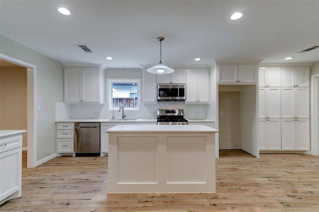 Beautiful kitchen with newer appliances and kitchen island.