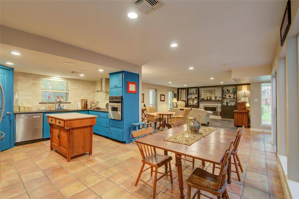 The bright breakfast area at the front of the photo opens to the kitchen and offers a seamless view into the formal dining and living rooms.