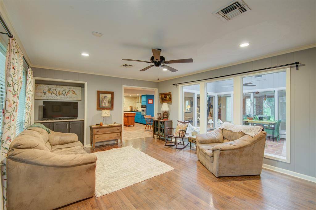 From the family room, enjoy a stunning view into the glass atrium on the right and a clear sightline to the kitchen straight ahead, enhancing the home’s open feel.