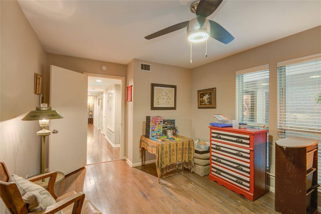 This view reveals the room’s connection to the hallway leading to additional bedrooms, enhancing its accessibility and flow.