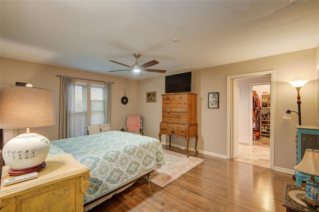 Alternate angle of the primary bedroom highlights the direct entry to the ensuite bath, adding convenience and privacy to this relaxing space.