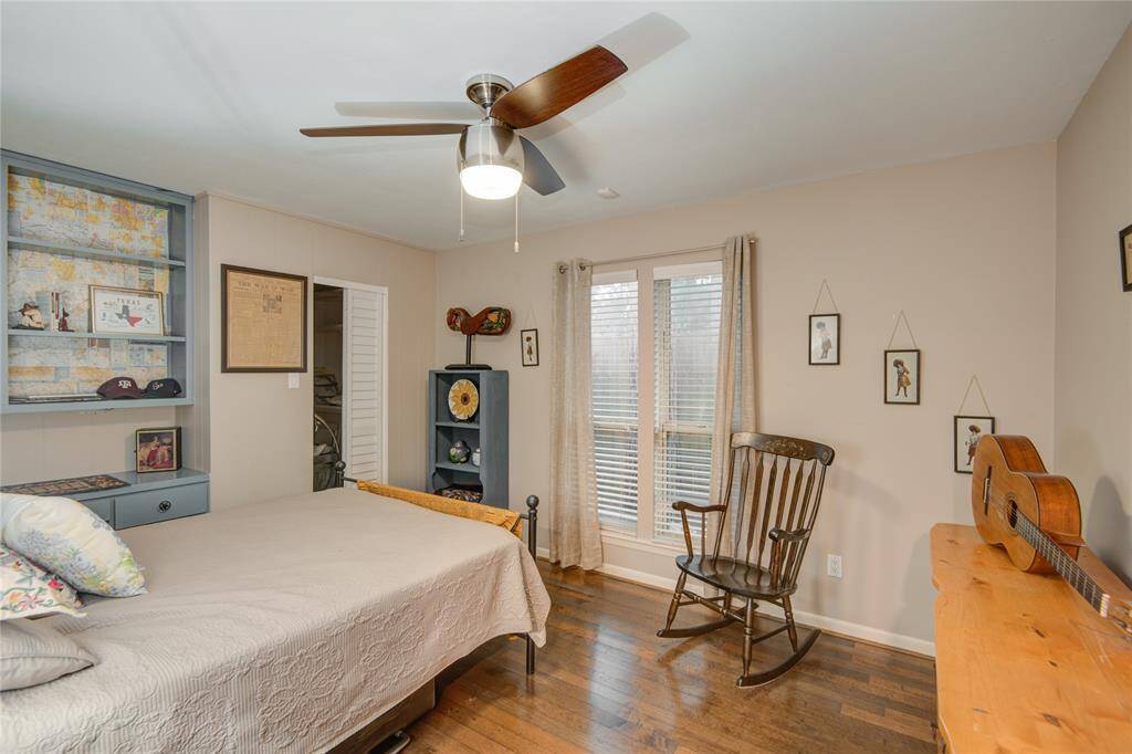 This secondary bedroom, currently used as a guest room, features custom built-ins, providing both functionality and style.