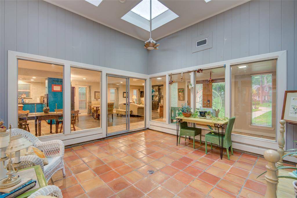 This view of the atrium reveals the home's front entry to the right and the kitchen to the left, creating a central, inviting space that connects the home’s key areas.