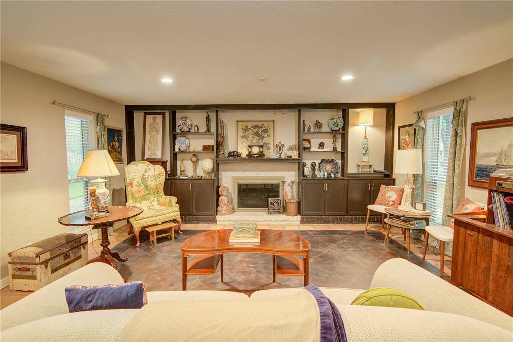 This inviting living space features a classic fireplace framed by custom built-ins for both style and storage.