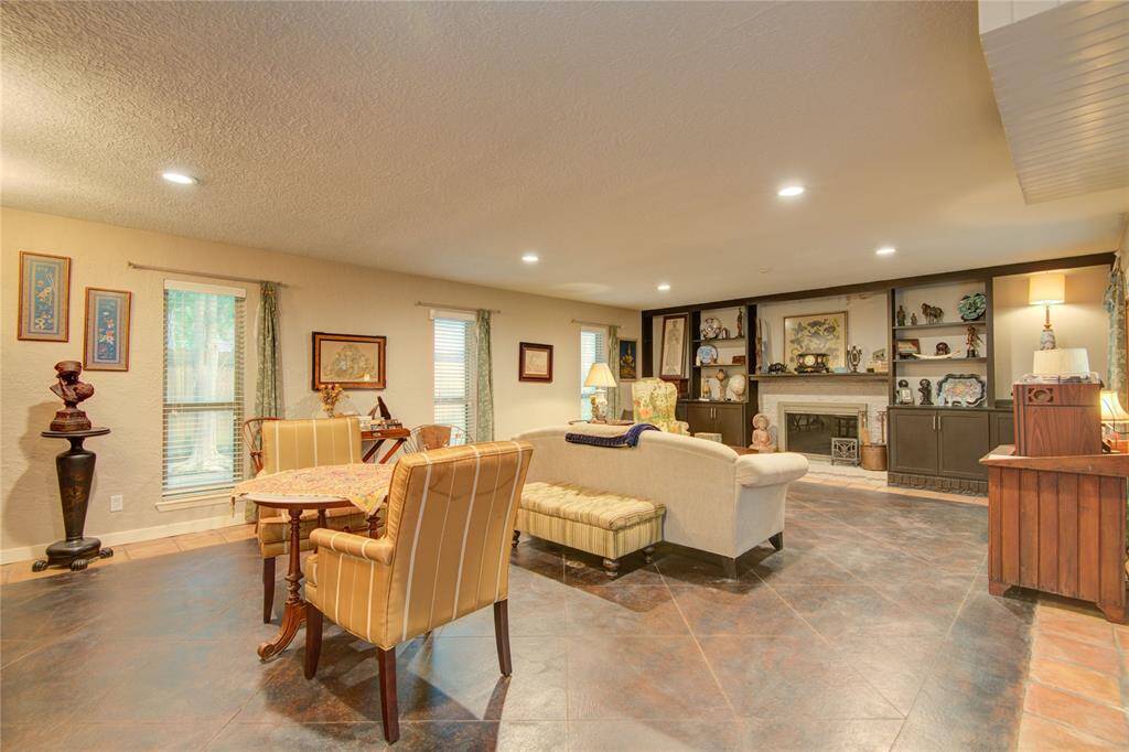 The elegant dining area with recessed lighting and abundant natural light opens seamlessly to the formal living space.