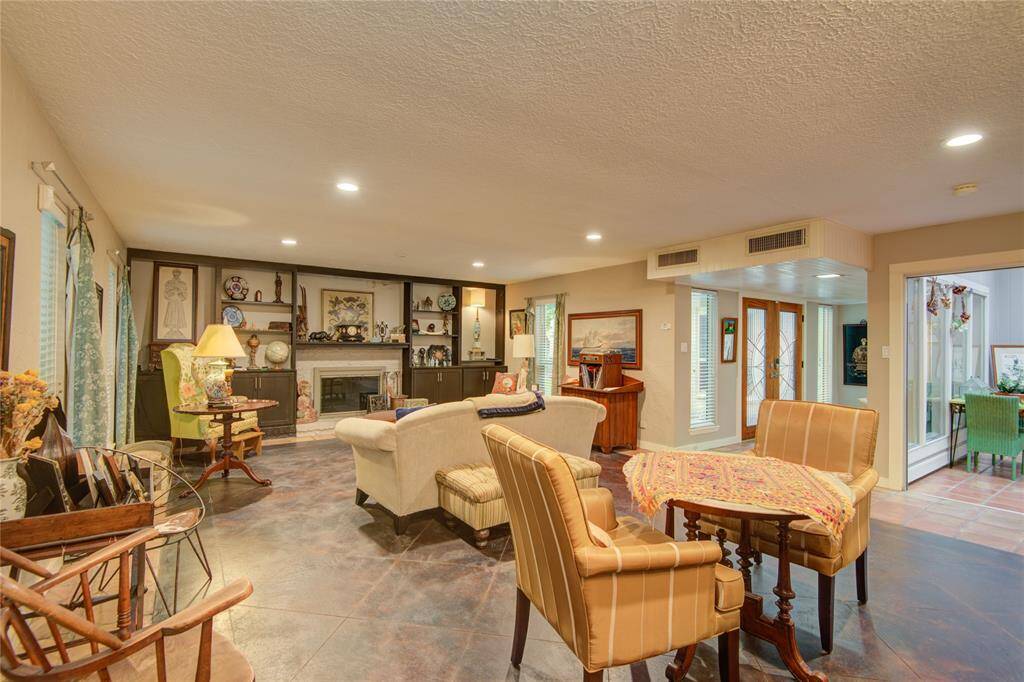 The formal dining area sits gracefully at the forefront, with views of the front entry and central atrium just beyond.