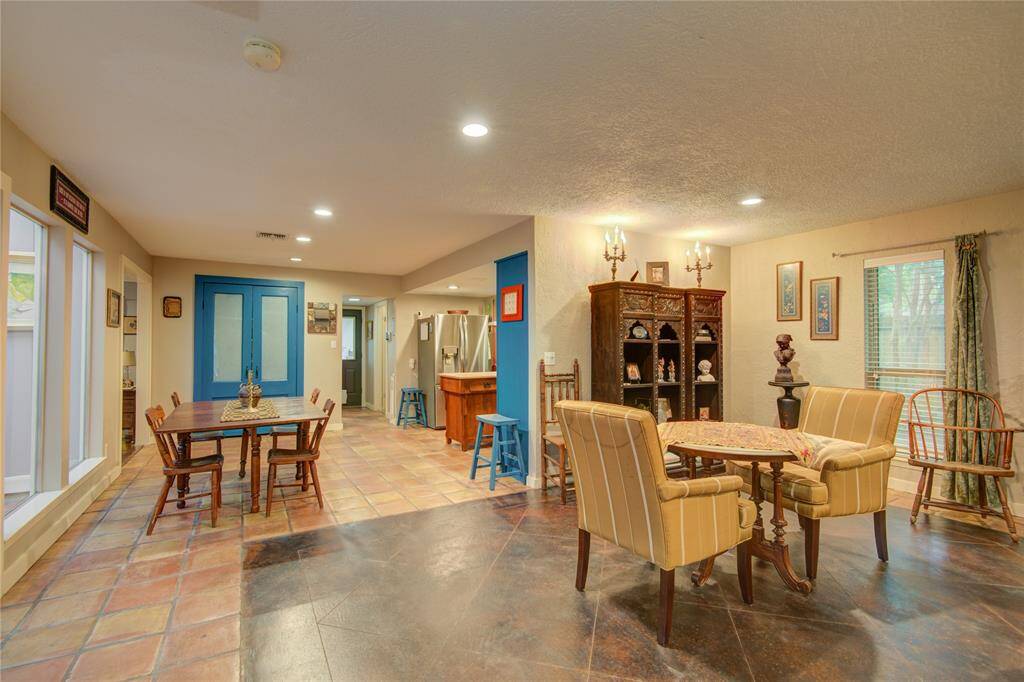 From the formal dining room, enjoy a view into the cheerful breakfast area and kitchen, with double doors ahead leading to one of two pantry spaces.