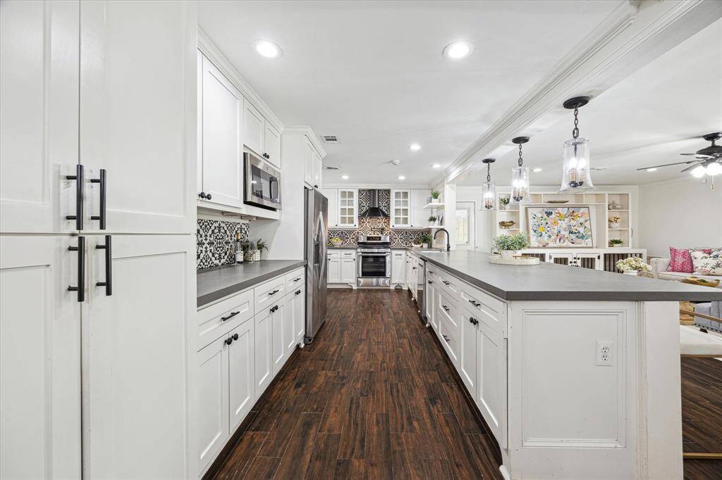The galley kitchen is open to the living room and has a breakfast bar and tons of storage and all stainless steel appliances.