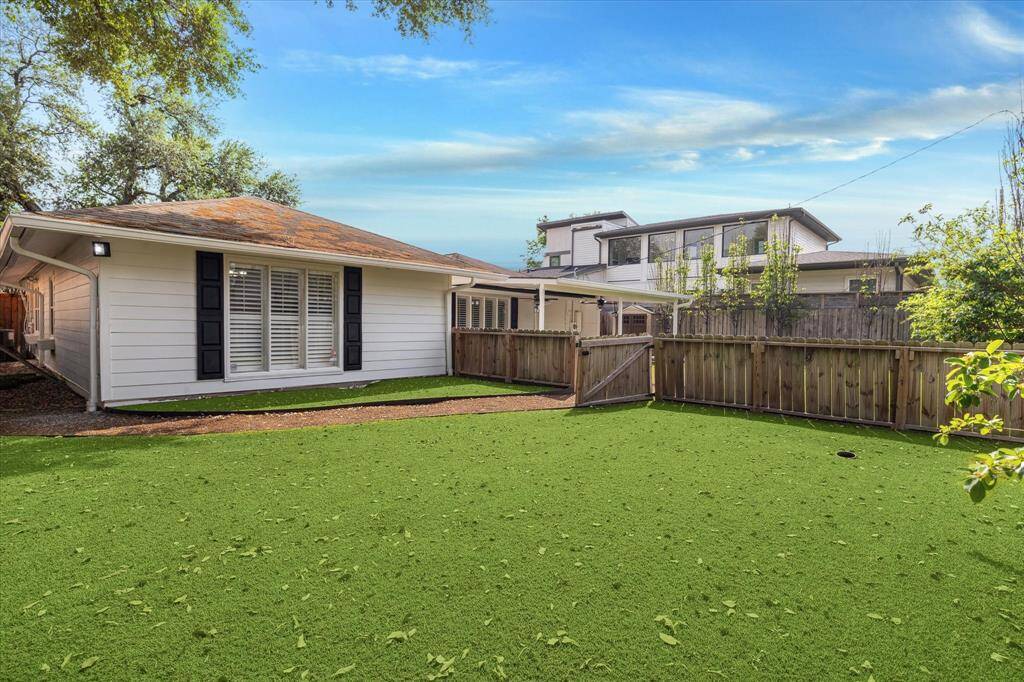 The huge turfed backyard is separated in the middle and is perfect for pets.