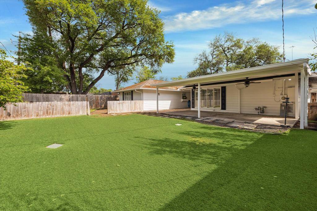 Another view of the huge, turfed backyard that is large enough for a pool. The covered patio is the perfect place to relax or entertain.