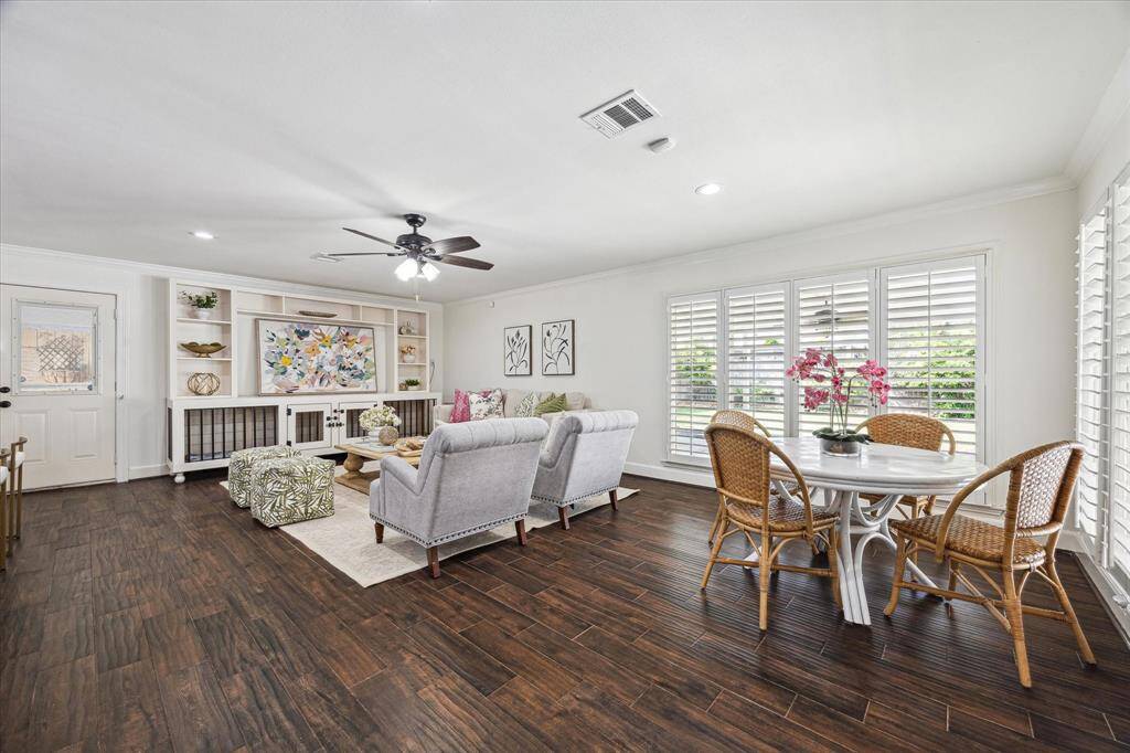 The spacious Living Room has beautiful windows that let in a lot of light and overlooks the backyard.Plantation shutters, crown molding and tile flooring is throughout the home.