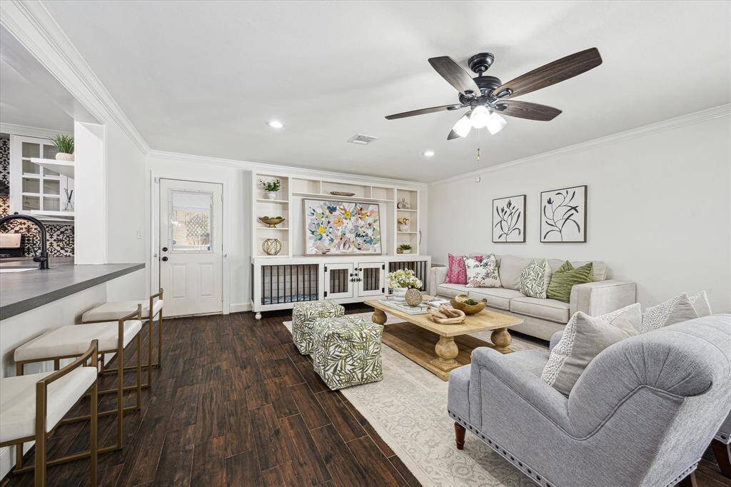 The Living room has built in cabinets that has a dog kennel built into the bottom and has direct access to the backyard.