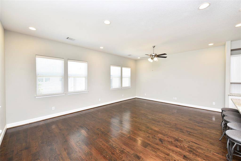 Another view of the living area, showcasing its beautiful wooden floors.