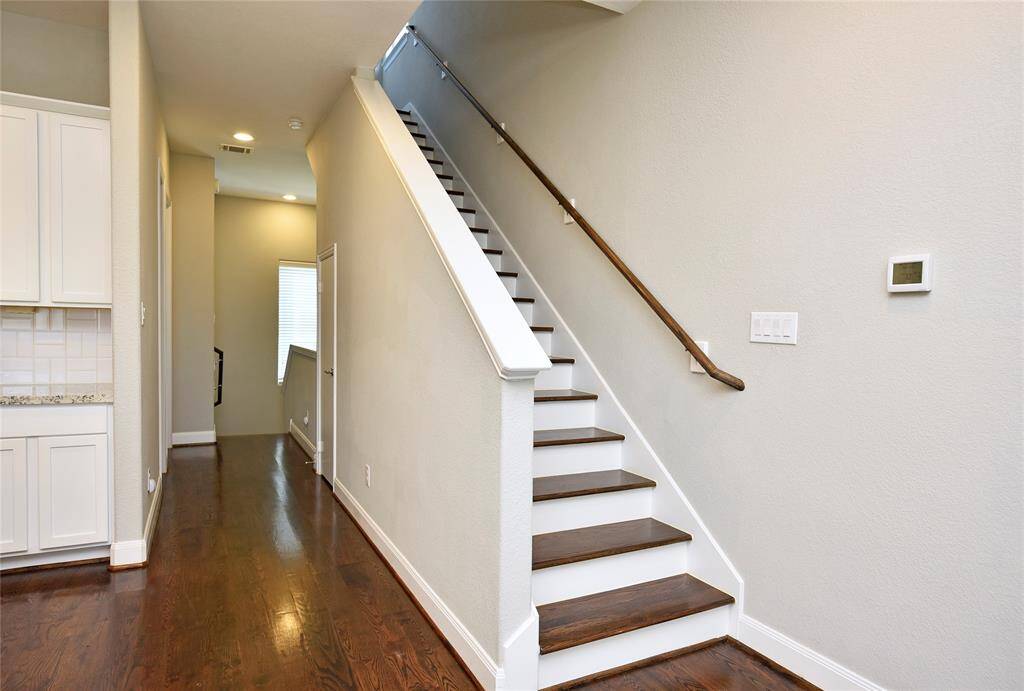 "Wooden stairway leading to the third floor."