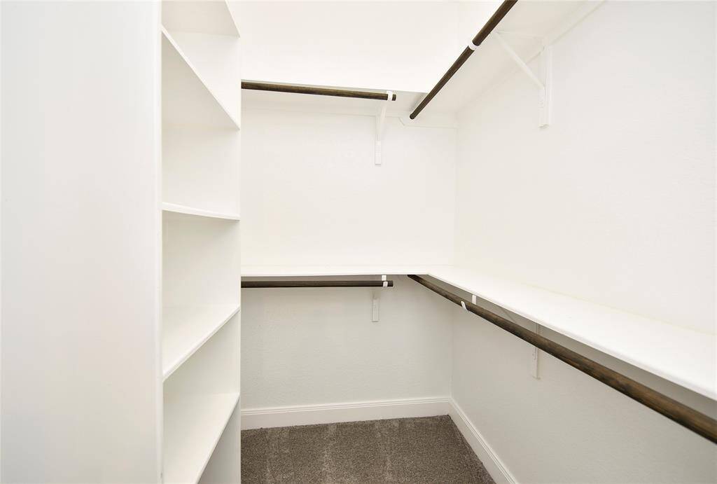 Spacious primary closet with ample room for all your wardrobe essentials.