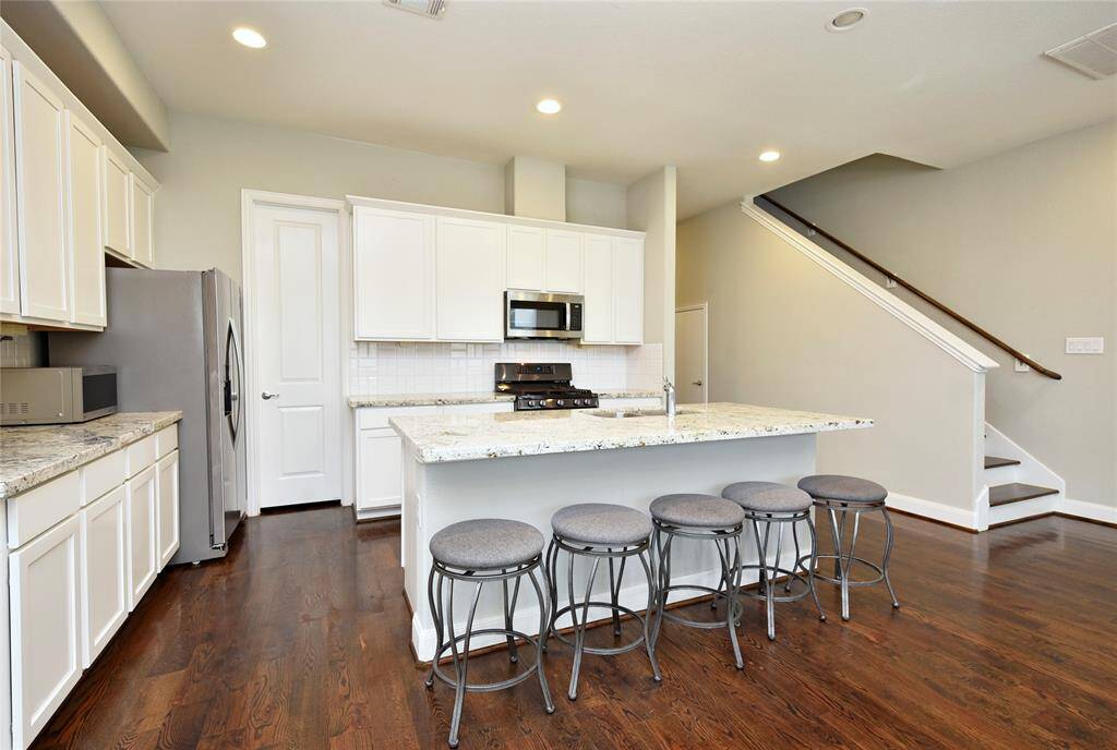 The gourmet kitchen features an oversized granite island with plenty of space for seating.