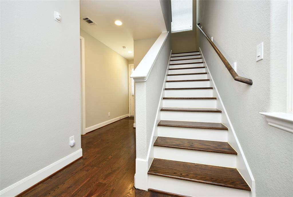 "Elegant Wooden Stairway Leading to the Second Floor"