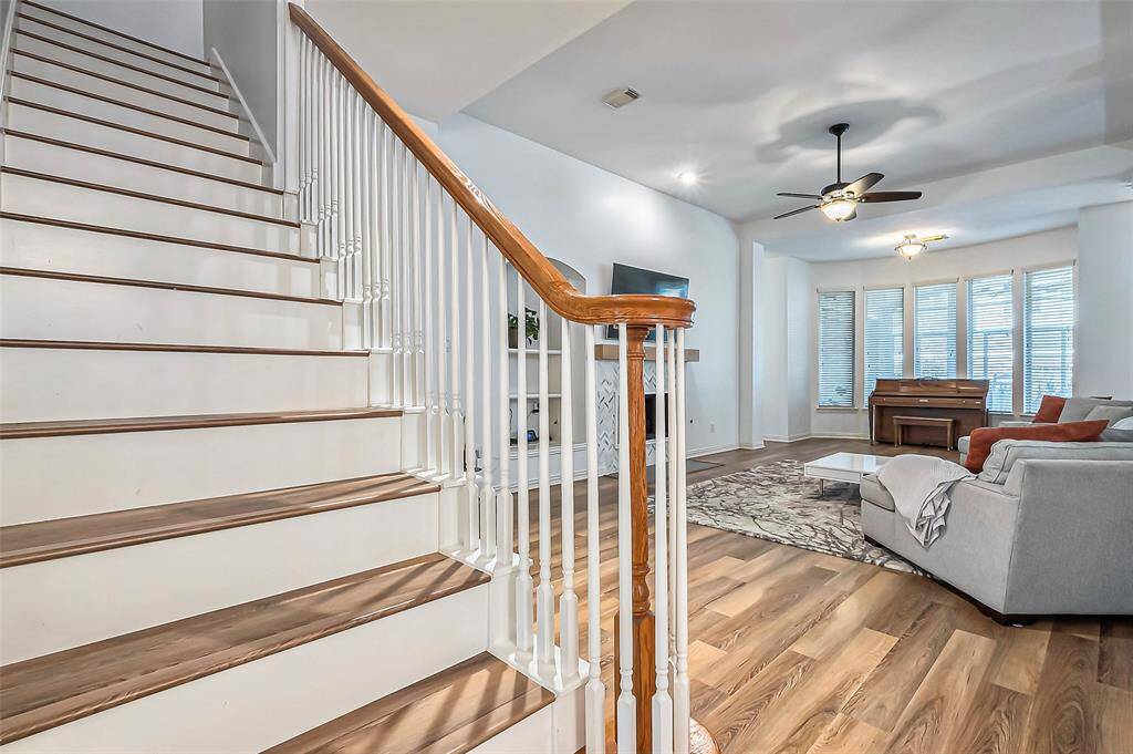 A sneak peek of the living room from the elegant staircase with painted risers