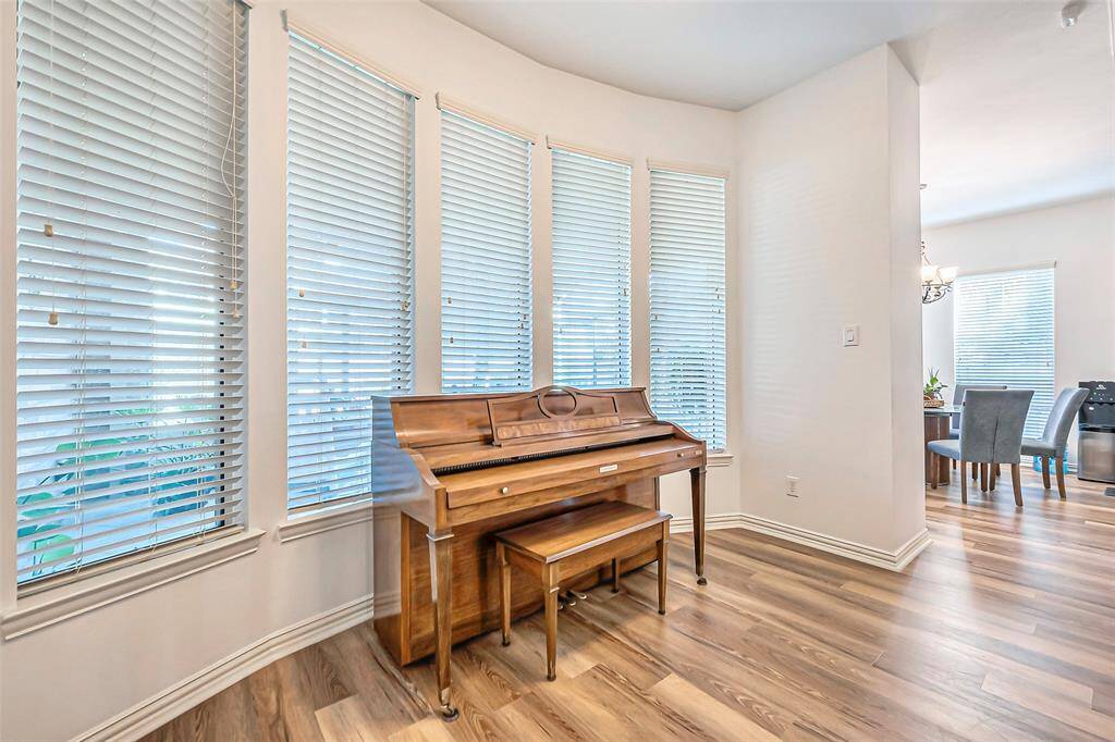 Relax in the natural light allowed in by this wall of windows in the living room facing the sunroom