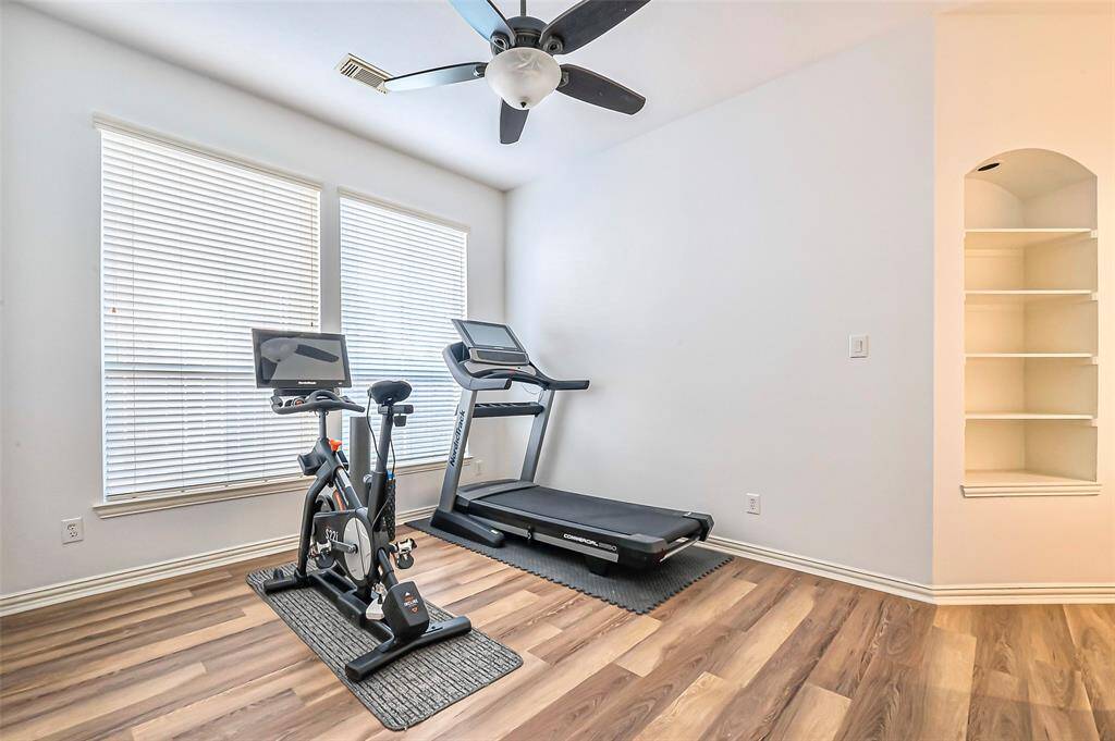 Downstairs game room with lots of natural light and built in shelving