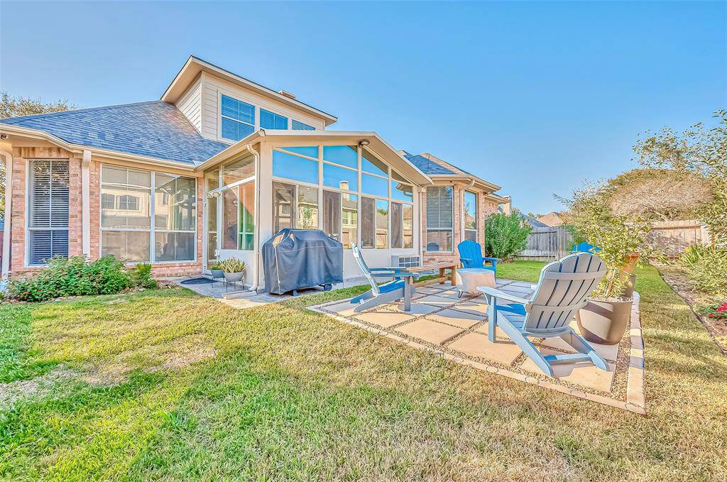 View of the large backyard with sun room and deck, great to entertain!