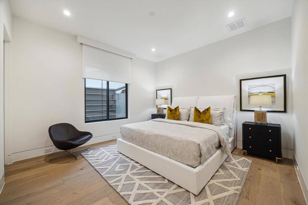 Bedroom #3 is located on the first floor with en-suite bathroom features, electric solar shade by Hunter Douglas, and 9" wide White oak flooring.