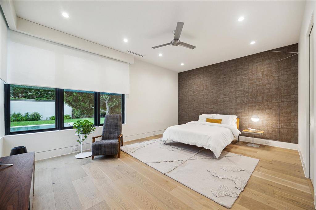 Bedroom #2 is truly a JUNIOR SUITE with fantastic pool views, and the back wall is covered by an elegant linen wallpaper, and the window is covered by electric solar shades and blackouts. Spacious walking closet built by LEICHT