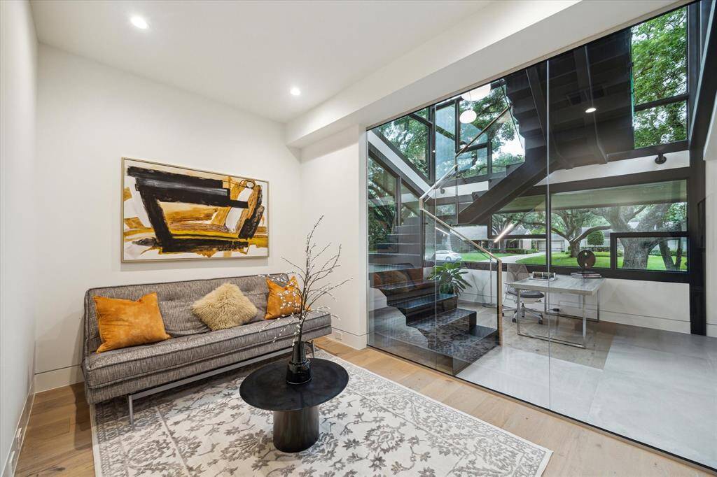 Guest Room #4 fits a queen-size bed, and roller shades from floor to ceiling cover the glass wall for privacy.