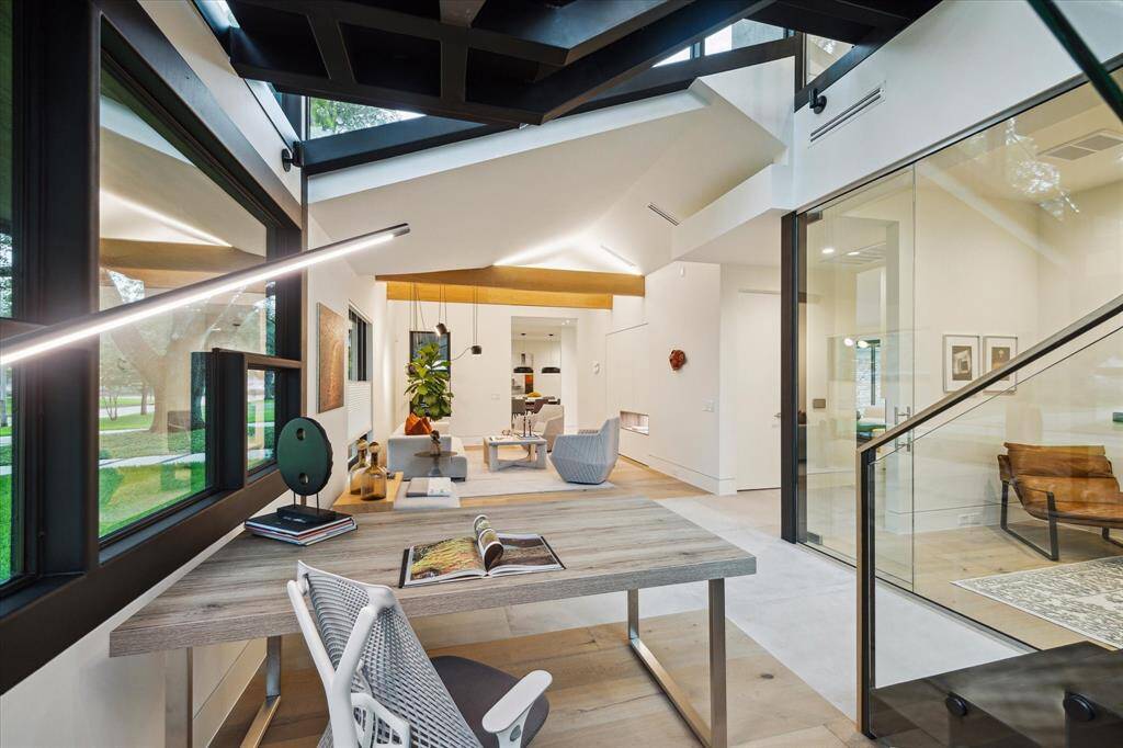 A minimalistic open-concept office area provides a clean and uncluttered workspace, promoting focus and productivity. Its design emphasizes simplicity, with sleek lines and functional furniture, creating a modern and efficient environment.