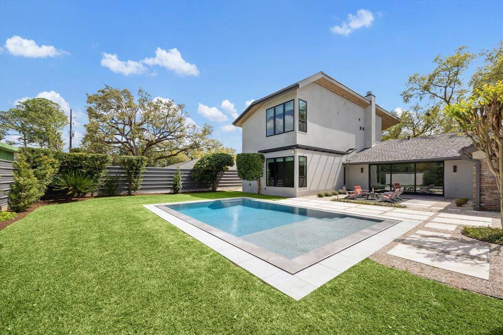 This home sits on a 14,250 SF Lot! An Infinity-Edge HEATED Pool with light enhances the lush landscaped yard.