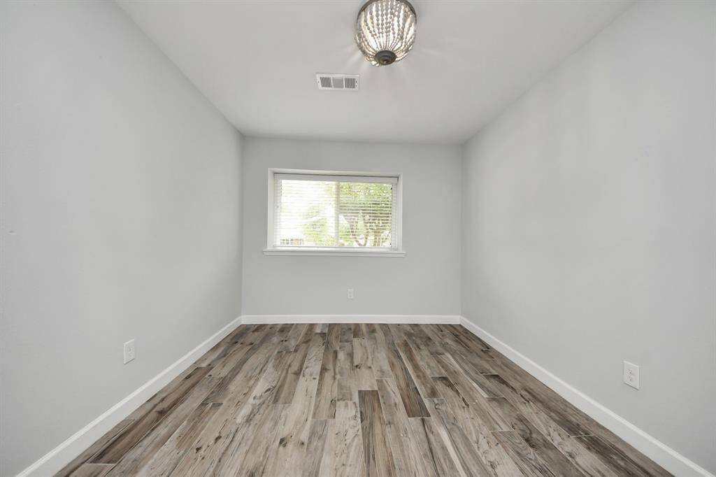 This well-appointed secondary bedroom offers comfort and versatility, perfect for use as a guest room, home office, or child’s bedroom