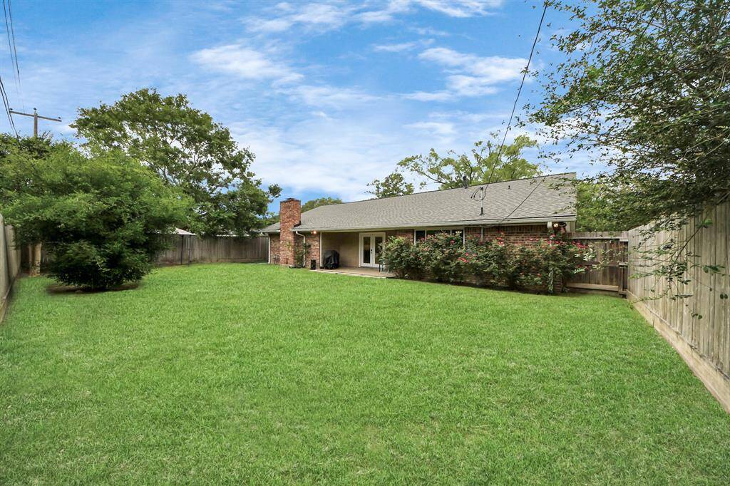 spacious and inviting backyard designed for both relaxation and entertaining