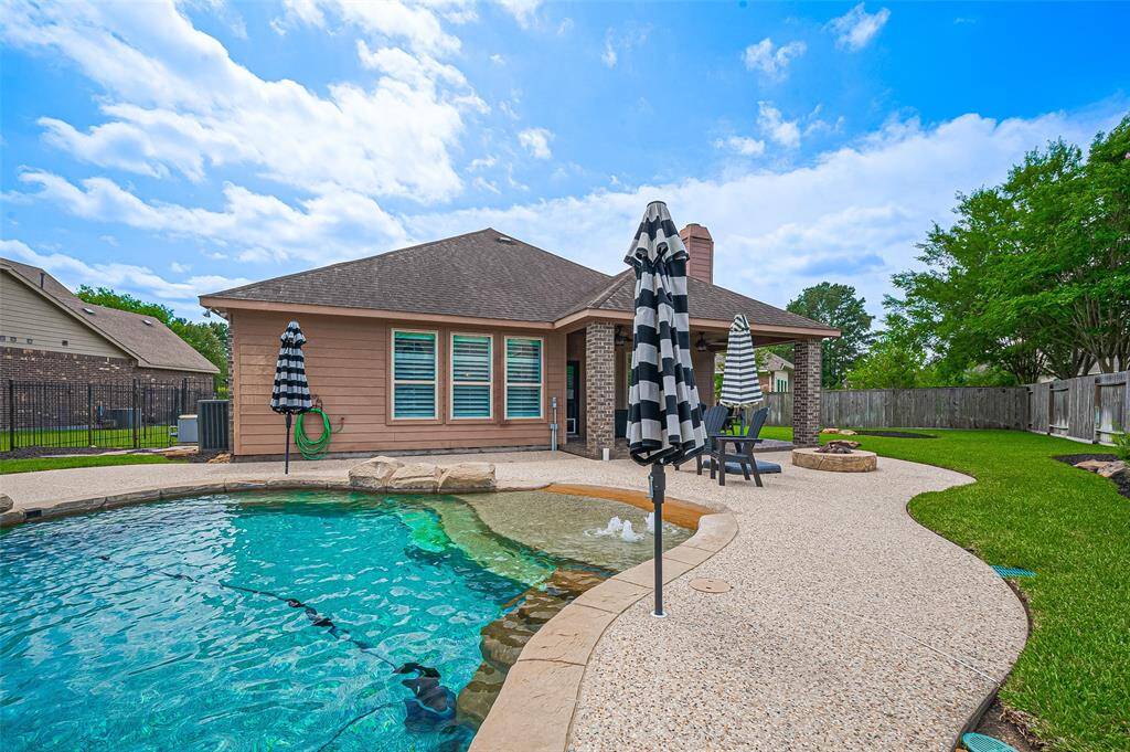 Expansive decking area surrounding the pool.