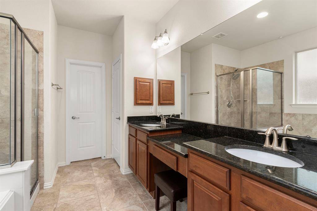 Primary bathroom with double sinks and vanity.