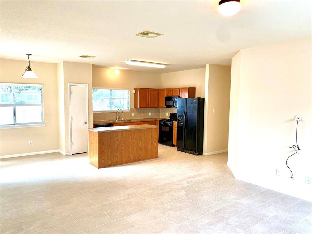 View from the family room to breakfast nook, pantry, and kitchen