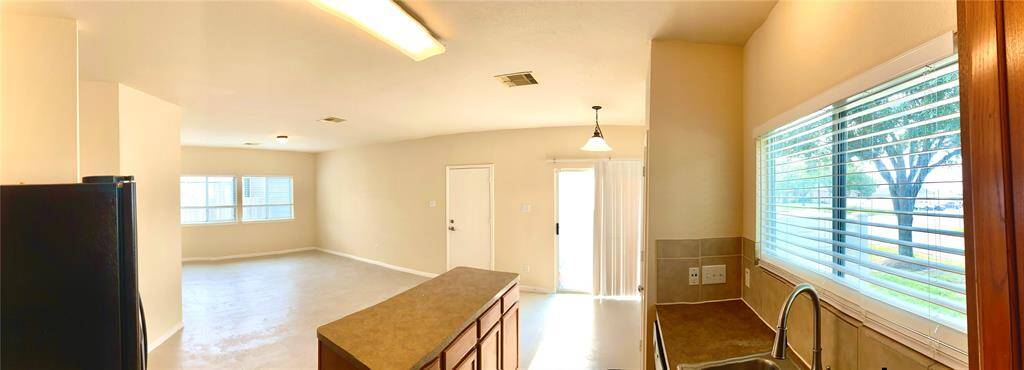 Pano from kitchen, showing family room, dining/breakfast nook, and comfortably designed kitchen with entering right at hand