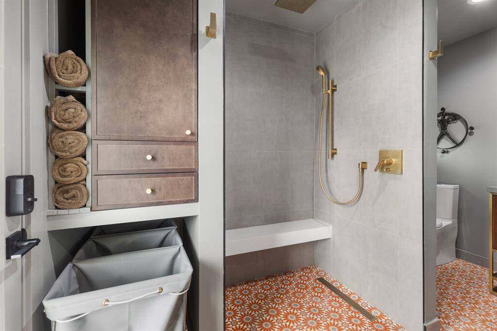 The luxurious primary bath features a spacious shower with modern finishes and fixtures.