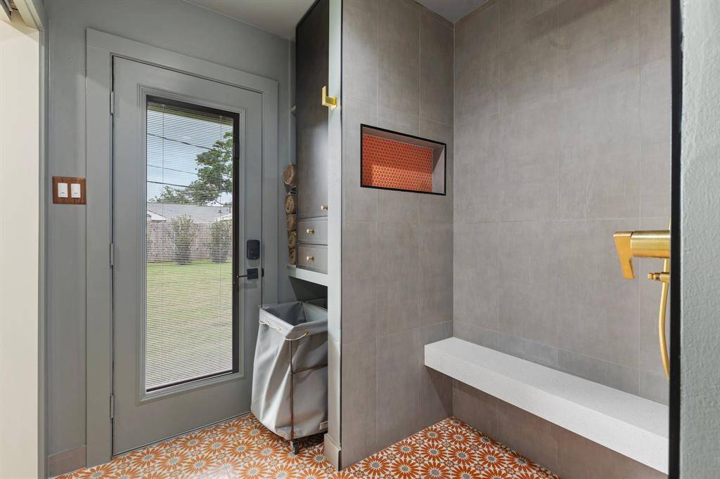 The primary bath also features a secure door to the back yard which offers a great option for outdoor entertaining.