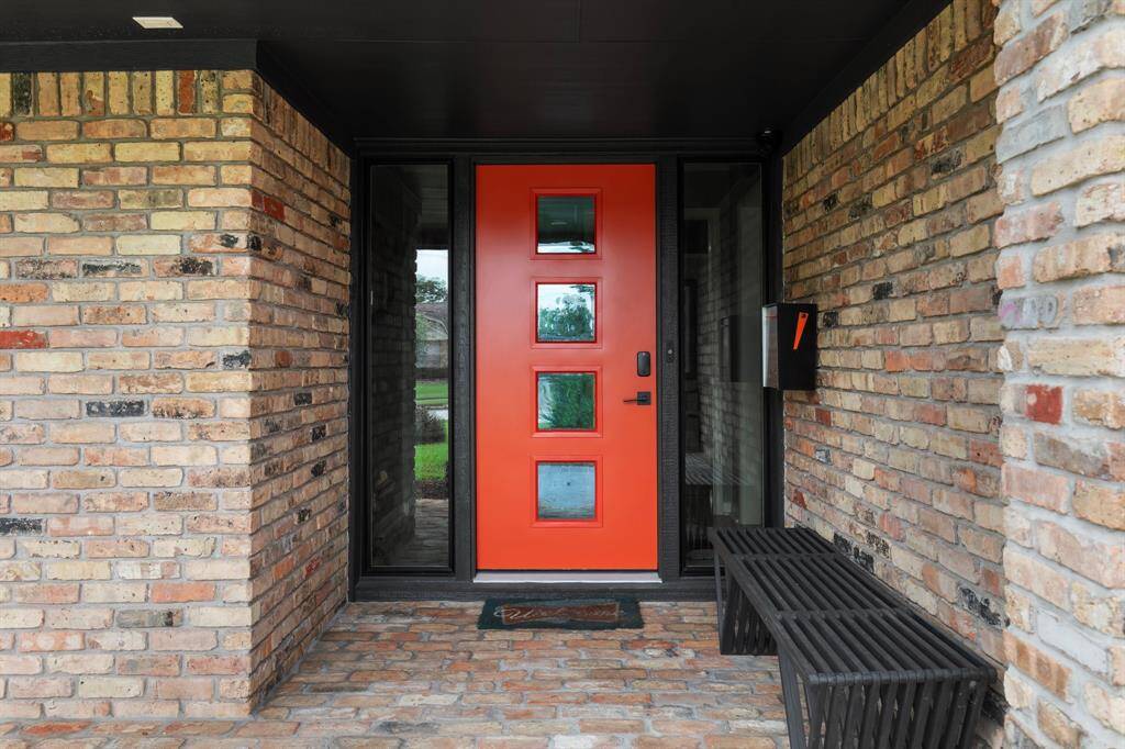 The entry was updated with a new mid-century style door and brick