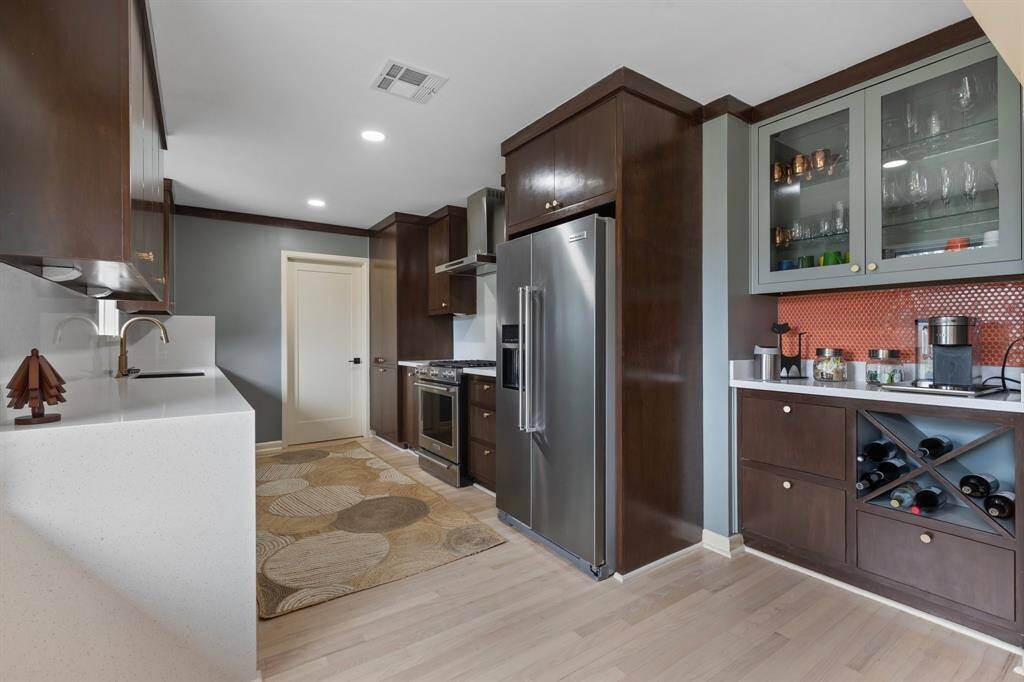 The fully updated kitchen features solid Maple cabinets, plenty of storage and quartz counter tops.