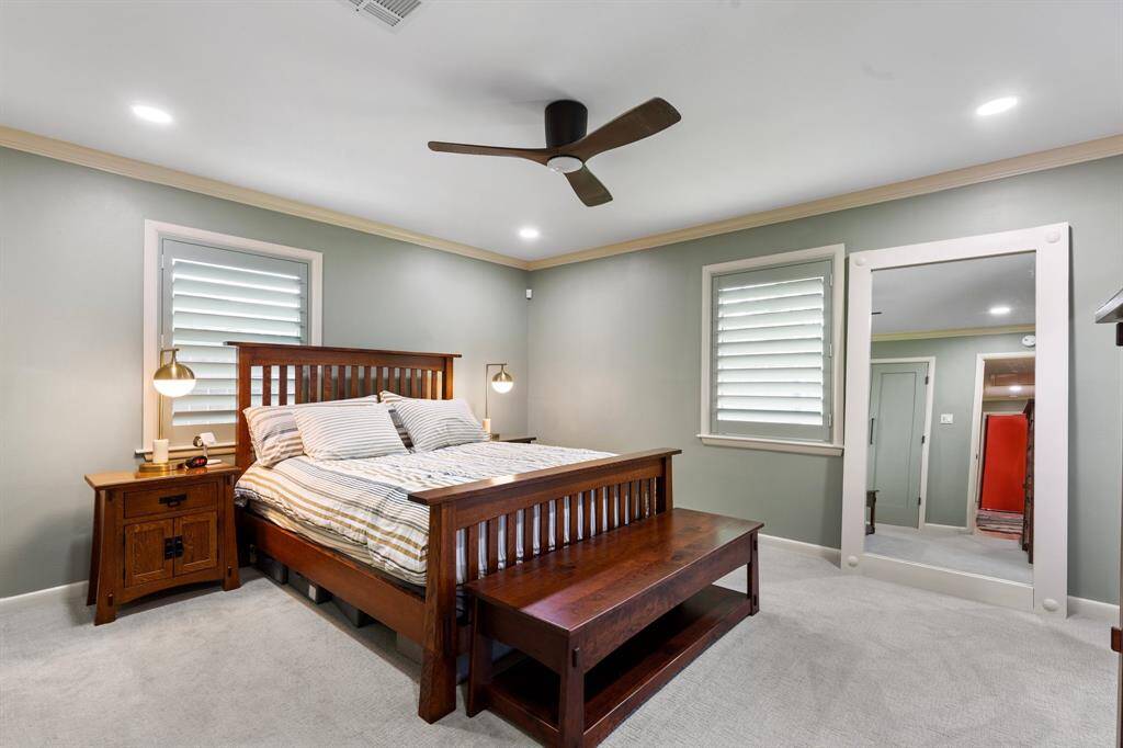 The primary suite features good closet space, window shutters, recessed lights and a modern ceiling fan.  Per the seller, the wood floors continue under the carpet in this room.