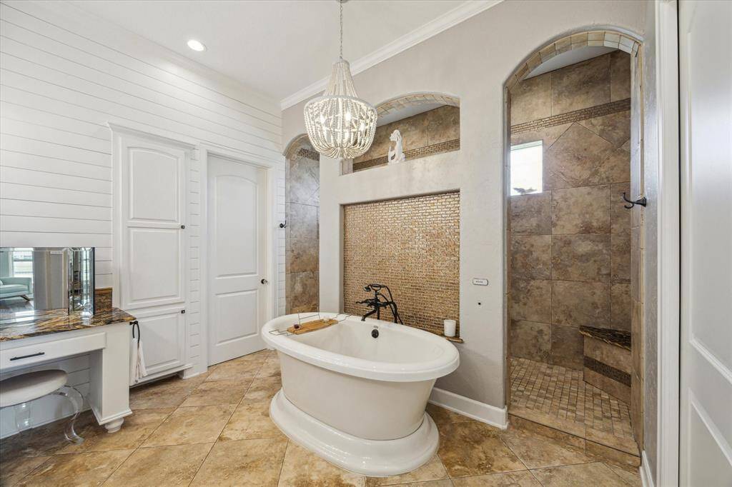 Freestanding soaking tub centered in the room, offering a spa-like centerpiece.