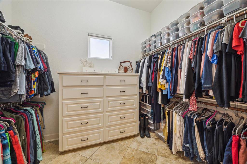 Primary suite's oversized walk-in closet.