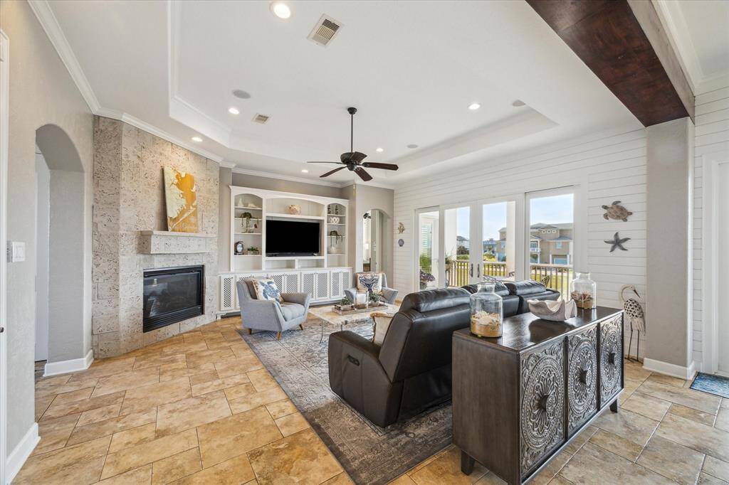 This waterfront home's living area is a showcase of refined elegance and comfortable luxury.