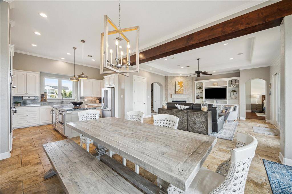 The interior features spacious, interconnected living and dining rooms, perfect for hosting large gatherings or intimate dinners with friends.