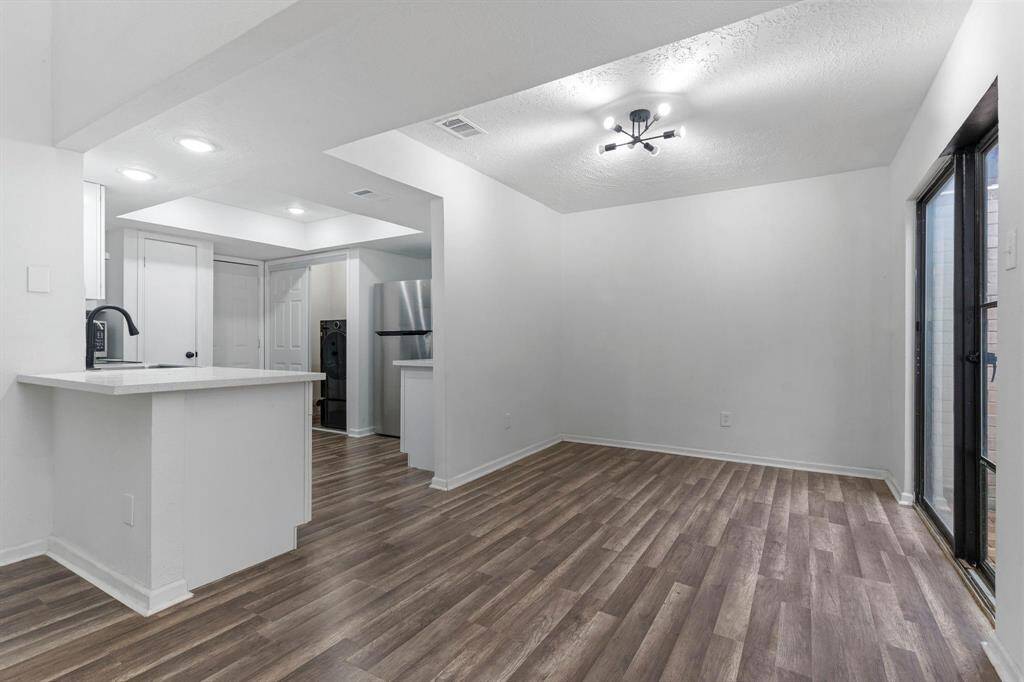 The updated gourmet kitchen features upgraded beautiful quartz countertops, breakfast bar and chic updated light fixtures and more!
