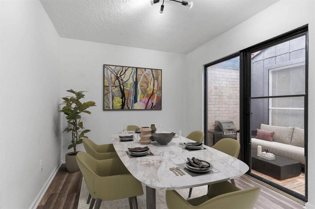 Wonderful casual dining area open to the family area and gourmet kitchen.  Notice all those beautiful carefree wood like flooring!  Open the sliding door to the atrium for that cup of hot tea in the morning for relaxing!